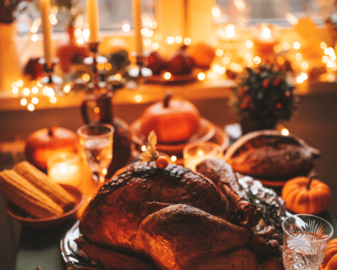 Thanksgiving Dinner with turkey and orange candle light